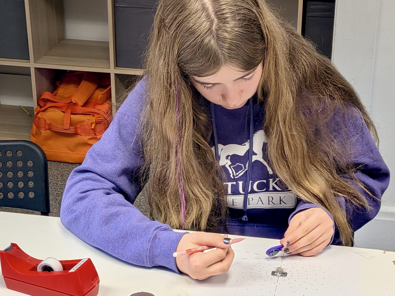 An elementary student concentrating on a project