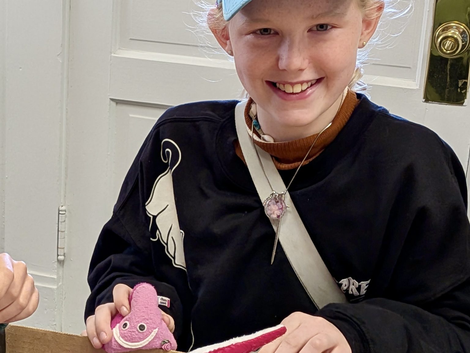 A smiling McGuffey student holding a science model